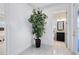 Foyer with plant features tile flooring and an open view into the bathroom at 13349 Alderley Dr, Orlando, FL 32832