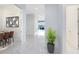 Bright hallway with tile floors, plant, and a view of the outdoors and dining room at 13349 Alderley Dr, Orlando, FL 32832