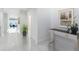A spacious hallway featuring neutral walls, recessed lighting, tiled floors, and modern decor at 13349 Alderley Dr, Orlando, FL 32832