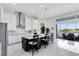 Bright open kitchen features a large granite island, stainless appliances, and seamless access to outdoor living at 13349 Alderley Dr, Orlando, FL 32832