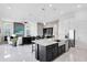 Bright open kitchen and living area with stainless appliances and a granite island at 13349 Alderley Dr, Orlando, FL 32832