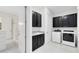 Laundry room with black cabinetry, granite counters, and modern appliances at 13349 Alderley Dr, Orlando, FL 32832