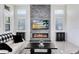 Bright living room features a stone fireplace and backyard views at 13349 Alderley Dr, Orlando, FL 32832