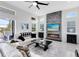 Bright living room features a stone fireplace and backyard views at 13349 Alderley Dr, Orlando, FL 32832