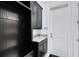 Mudroom boasts dark wood cabinets and hooks, granite counters and white door at 13349 Alderley Dr, Orlando, FL 32832
