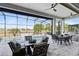 Screened-in patio area with a view of the pool, outdoor kitchen, dining, and comfortable seating at 13349 Alderley Dr, Orlando, FL 32832