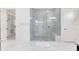 Bathroom with a large glass shower featuring white tile and a marble floor and bench at 13349 Alderley Dr, Orlando, FL 32832