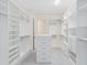 A large walk-in closet features built-in shelving and drawers at 13349 Alderley Dr, Orlando, FL 32832