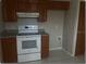 Functional kitchen featuring an electric range, ample cabinet space, and tiled floors at 1415 Meadowlark St, Longwood, FL 32750