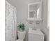 Cozy bathroom with a decorative shower curtain and vanity with a shelf at 1633 Colton, Orlando, FL 32822