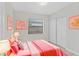 The cozy bedroom includes tile flooring, closet, and artwork at 1633 Colton, Orlando, FL 32822