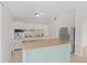 A well-lit kitchen boasts white cabinetry, stainless steel appliances and a granite-topped island at 1633 Colton, Orlando, FL 32822