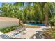 Inviting backyard featuring a pool, a brick patio with a table, and lush tropical landscaping, creating a private outdoor oasis at 1638 Mount Vernon St, Orlando, FL 32803