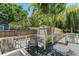 Back deck with dark wood floors offers a scenic view of the fenced backyard with a detached garage at 1638 Mount Vernon St, Orlando, FL 32803