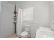 Bright bathroom featuring a tiled shower with a white shower curtain and modern fixtures at 1638 Mount Vernon St, Orlando, FL 32803