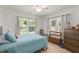 Bright bedroom with three large windows and wood flooring, offering plenty of natural light and warmth at 1638 Mount Vernon St, Orlando, FL 32803