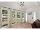 Bright sunroom featuring hardwood floors, neutral paint and many windows at 1638 Mount Vernon St, Orlando, FL 32803