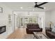 Bright living room featuring hardwood floors, neutral paint, ceiling fan and fireplace at 1638 Mount Vernon St, Orlando, FL 32803