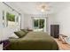 Bright main bedroom featuring ceiling fan, dresser, and sliding glass door to backyard at 1638 Mount Vernon St, Orlando, FL 32803
