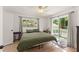 Bright main bedroom featuring ceiling fan, dresser, and sliding glass door to patio at 1638 Mount Vernon St, Orlando, FL 32803