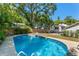 Backyard pool surrounded by mature trees, offering a private and serene setting for relaxation and outdoor enjoyment at 1638 Mount Vernon St, Orlando, FL 32803