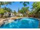 Backyard with a sparkling pool, patio with table and chairs, and a charming house, offering a perfect blend of relaxation and comfort at 1638 Mount Vernon St, Orlando, FL 32803