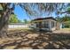View of the home's backyard shaded by a large tree at 1807 Yorkshire Dr, Winter Park, FL 32792