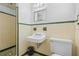 Bathroom featuring tiled walls, a white sink, medicine cabinet, and a toilet at 1807 Yorkshire Dr, Winter Park, FL 32792