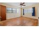 A bedroom with hardwood floors, natural light from windows and potential for updating at 1807 Yorkshire Dr, Winter Park, FL 32792