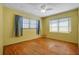 Bedroom with wooden floor, ceiling fan, natural light, and potential for updating at 1807 Yorkshire Dr, Winter Park, FL 32792