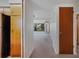 Hallway leading to a living area with neutral carpet and view of the window at 1807 Yorkshire Dr, Winter Park, FL 32792