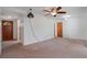 A simple living room, featuring a ceiling fan, outdated carpets, and potential for updates at 1807 Yorkshire Dr, Winter Park, FL 32792