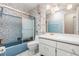 Bathroom with stylish blue tile, white cabinets, bathtub and clear glass shower doors at 2508 Osage Trl, Fern Park, FL 32730