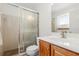 Bathroom featuring a tiled shower, a white sink, and cherry wood cabinets at 2508 Osage Trl, Fern Park, FL 32730