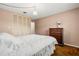 Cozy bedroom with hardwood floors, neutral walls, wooden dresser, and ample closet space at 2508 Osage Trl, Fern Park, FL 32730