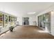 Bright lanai with carpeted floors, multiple windows, and sliding doors to the backyard at 2508 Osage Trl, Fern Park, FL 32730