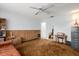 Spacious living room with wood paneled walls, ceiling fan, neutral carpet and comfortable leather couch at 2508 Osage Trl, Fern Park, FL 32730