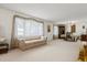 Spacious living room featuring neutral carpet, large windows, and ample seating space at 2508 Osage Trl, Fern Park, FL 32730