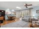 Open-concept living room with hardwood floors, comfortable seating and view of the kitchen at 2508 Osage Trl, Fern Park, FL 32730