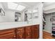 Main bathroom with dual mirrors, a white countertop, and cherry wood cabinets at 2508 Osage Trl, Fern Park, FL 32730
