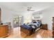 Bright main bedroom features hardwood floors, ceiling fan, and sliding doors to the lanai at 2508 Osage Trl, Fern Park, FL 32730