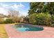 In-ground pool surrounded by lush landscaping and a stamped concrete deck at 2508 Osage Trl, Fern Park, FL 32730