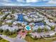 Extensive aerial view showcases the community with picturesque waterfront homes, lush landscaping, and a pool at 2568 Woodgate Blvd # 204, Orlando, FL 32822