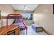 Bright bedroom featuring a bunk bed, window views, and tiled floors at 2568 Woodgate Blvd # 204, Orlando, FL 32822
