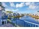 Waterfront condos overlooking canal, blue railings, with fountain and blue skies at 2568 Woodgate Blvd # 204, Orlando, FL 32822