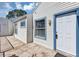 Exterior view of condo featuring vinyl siding, blue trim, front door, and concrete patio at 2568 Woodgate Blvd # 204, Orlando, FL 32822