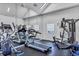 Well-equipped gym with treadmills, elliptical machines, and weight-training equipment at 2568 Woodgate Blvd # 204, Orlando, FL 32822