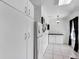 Bright kitchen with white cabinets, tiled floors, and modern appliances, offering a clean and functional space at 2568 Woodgate Blvd # 204, Orlando, FL 32822
