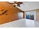 Stylish living room with tiled floors, accent wall, and sliding door to balcony at 2568 Woodgate Blvd # 204, Orlando, FL 32822