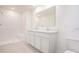 Well-lit bathroom with a double sink vanity, ample countertop space, and a walk-in shower at 307 Corsica Ct, Kissimmee, FL 34758